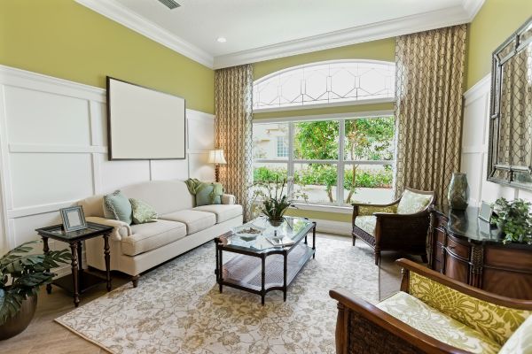 living room with two different sofa styles tied together with coordinating pillows and a shared rug.
